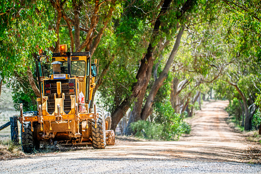 Machine used in earth works, digging and landscaping and making a road.