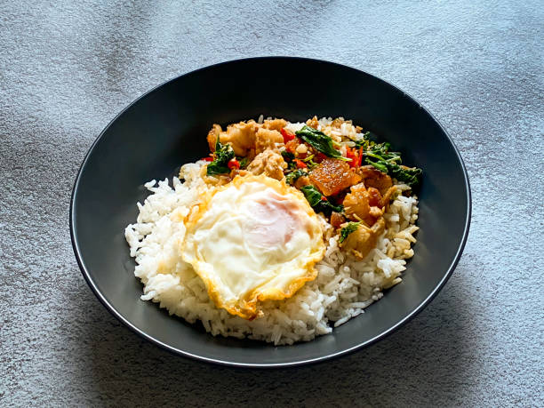 istock Rice topped with crispy pork belly with Thai basil and fried egg 2019243497