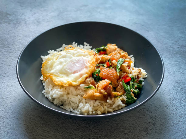 istock Rice topped with crispy pork belly with Thai basil and fried egg 2019243498