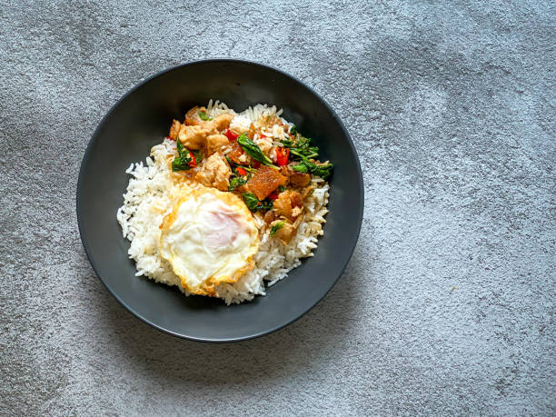 istock Rice topped with crispy pork belly with Thai basil and fried egg 2019243505