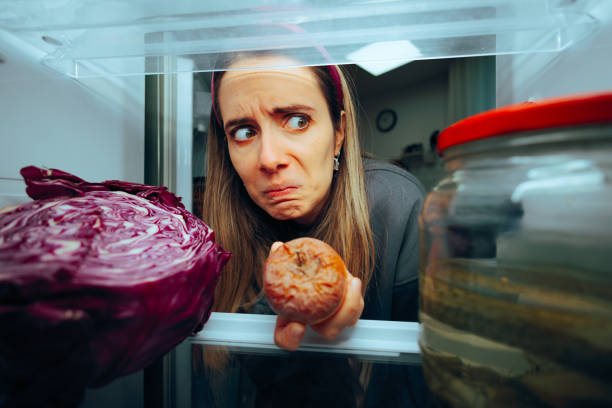 istock Woman Taking out a Rotten Fruit from her Fridge 2019266564