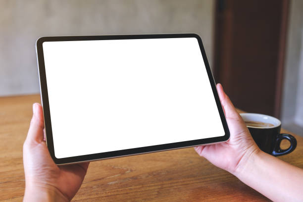istock Mockup image of a woman holding digital tablet with blank white desktop screen 2019267590