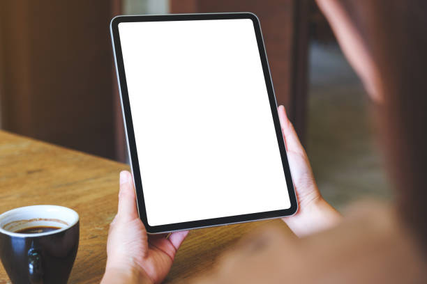 istock Mockup image of a woman holding digital tablet with blank white desktop screen 2019267592
