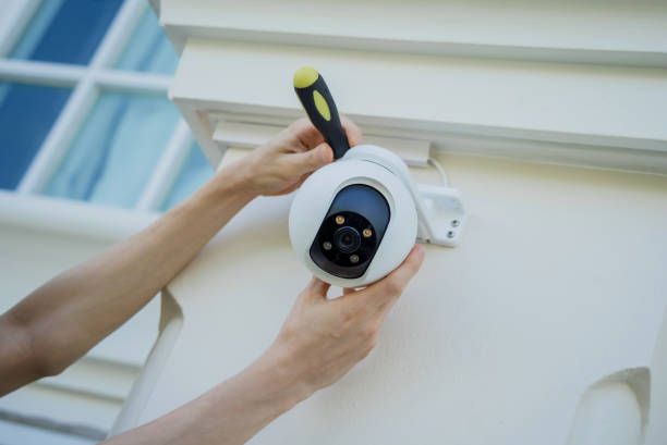 istock A technician installs a CCTV camera on the facade of a residential building. 2019303328