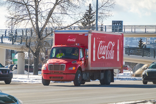 Calgary, Alberta, Canada. Feb 15, 2024. A transport vehicle, dedicated to the delivery of Coca-Cola products, navigates the wintry roads during the winter season.
