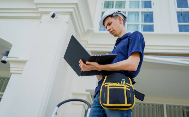 istock A technician sets up a CCTV camera on the facade of a residential building. 2019320211