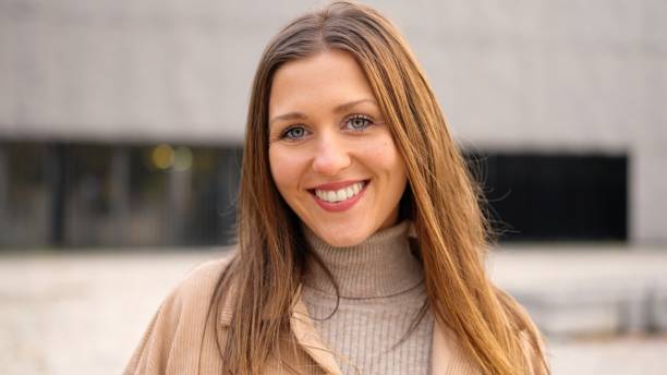 istock Young female student smiling at camera outdoors 2019341186