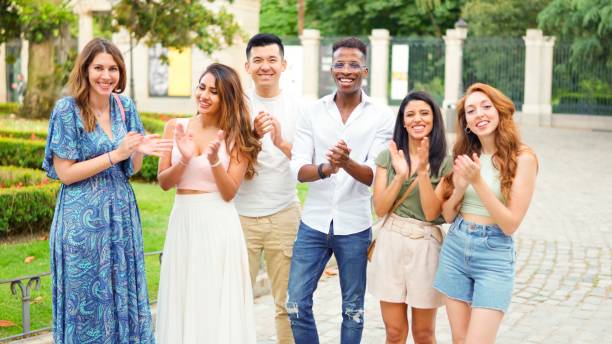 istock Friends applauding while looking at the camera outdoors 2019347515