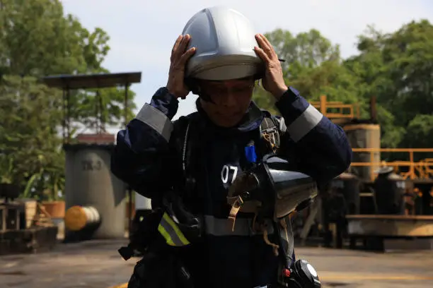 Photo of Rescue firefighter man wearing complete firefighting suit