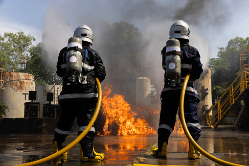 Worker demonstrates the use of fire extinguishers.