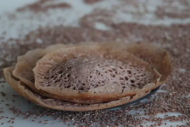 Laced navara rice Crepes or Navara rice appam. Fermented rice pancakes made with navara rice batter and coconut milk. A variation of favourite breakfast dish of Kerala called Appam or Hoppers.