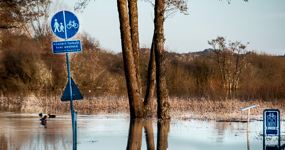 High water level in the river Vecht at the Vechterweerd weir in the Dutch Vechtdal region in Overijssel, The Netherlands. The river is overflowing on the floodplains after heavy rainfal upstream in The Netherlands and Germany during storm Eunice and Franklin in February 2022.