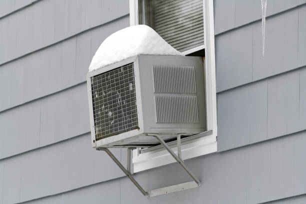 istock old air conditioner installed on house window with snow on top 2019464865