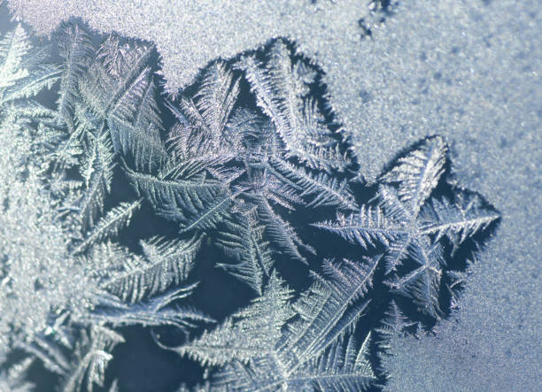 istock frost crystal on window glass in winter season 2019469014