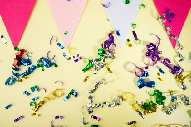 istock Celebration scene, yellow backdrop with confetti and holiday flags, cheerful ambiance, event decoration 2019485838