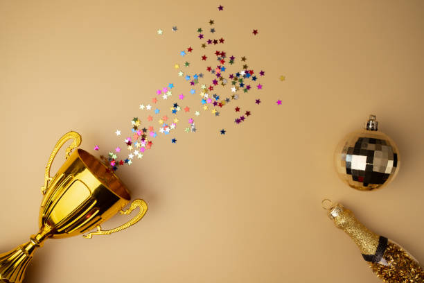 istock Winner's cup with confetti and champagne, celebratory background, trophy for success 2019486390