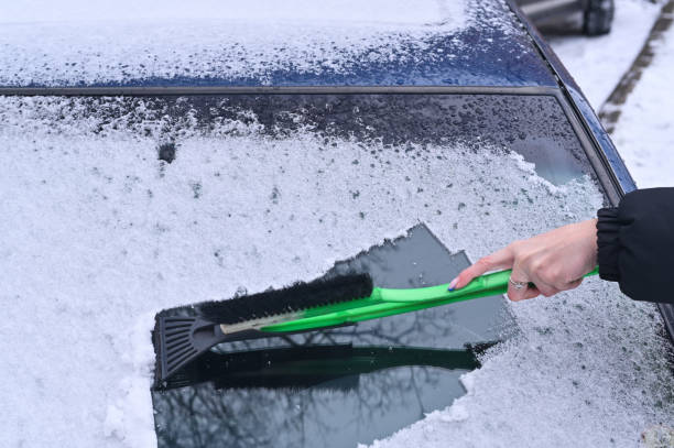 istock removing ice from the car window. close-up 2019497251