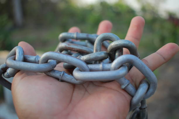 man hold heavy chain in hand