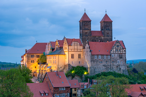 Quedlinburg, Germany - May 2019: Quedlinburg castle over old town in the evening