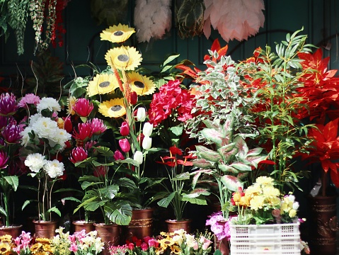 A sidewalk display of colorful flowers at a florist.