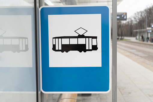Tram stop information road traffic sign in Poland. Tramway icon, public transport info plate on a stand, shelter, or booth shed.