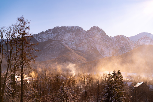 Giewont mountain massif, peak in the Tatra Mountains range, seen from Zakopane town, Poland. Part of Tatra National Park. Scenic landscape, iconic sleeping knight silhouette covered with winter snow.