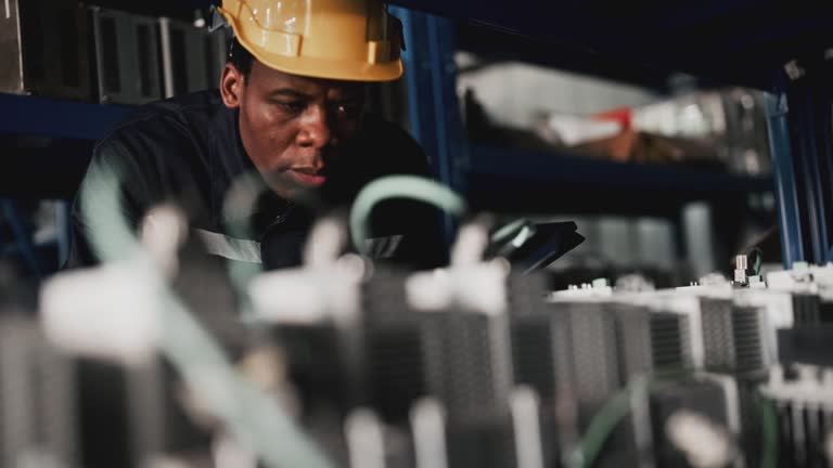 Male engineer inspecting at warehouse storage room.