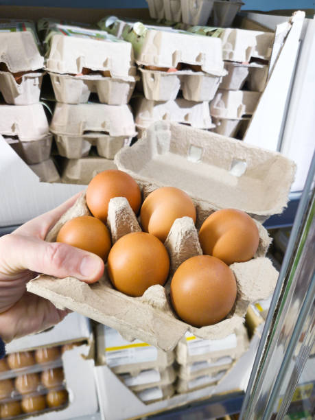 istock Hand with packages of eggs in store 2019620753