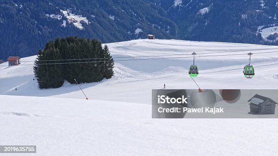 Ski Resort Slope with Cable Car Gondola Lift in Austrian Alps Mountains During Winter Season