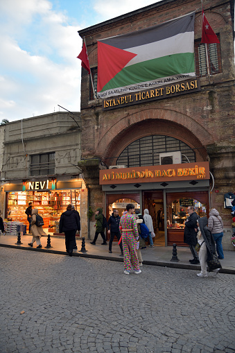 Istanbul, Turkey - December 12, 2023: Street scene in Istanbul. Palestine flag on facade of Chamber of commerce Istanbul Mercantile Exchange at Istanbul on Hamidiye Street