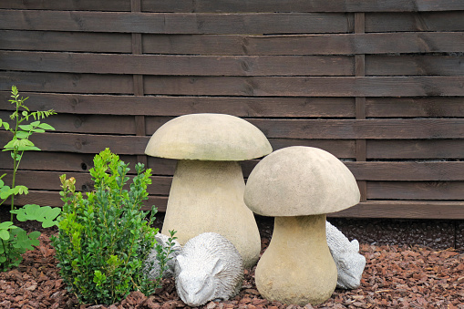 Garden design with plants and mushrooms and animals made of stone material.