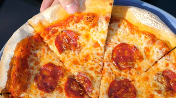 istock Delicious freshly baked pepperoni pizza being served on plate 2019675329