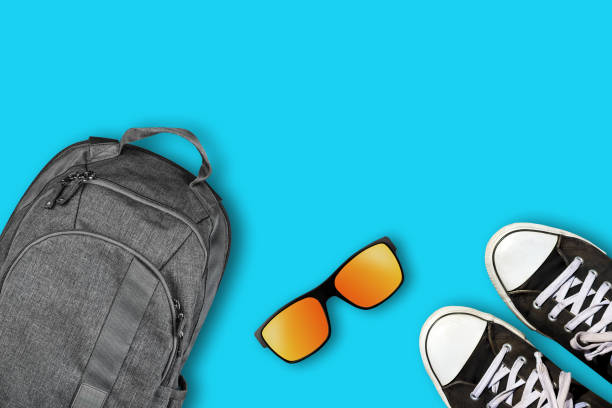 istock Backpack, sneakers, sunglasses on a blue background. Copy space. Top View. Travel concept. Travel 2019692256