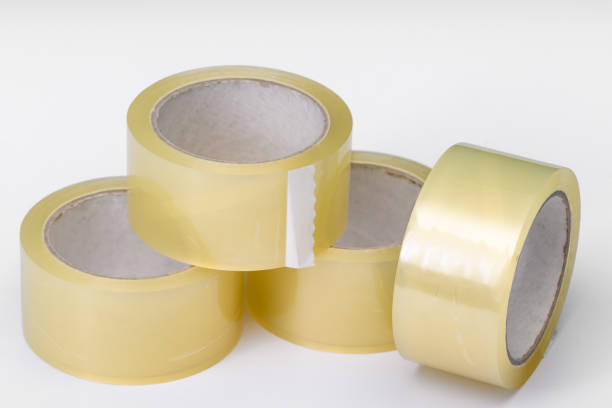 istock Several rolls of adhesive packing tape lie on a light background 2019735122