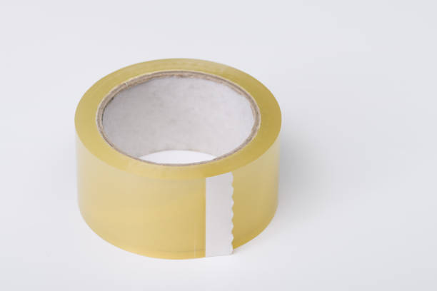 istock One single transparent wide adhesive tape on a roll on a light background 2019735129