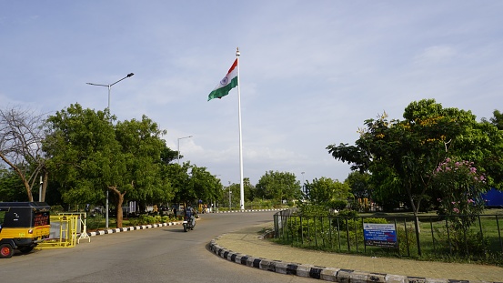 Madurai, India - July 30 2023: Indian national flag hoisted in Madurai Airport, Tamilnadu. Elegant tiranga with blue sky with cloudy background.