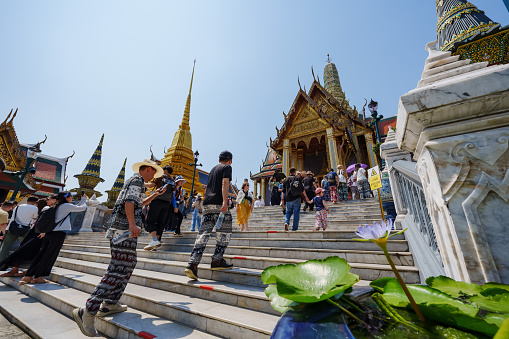 Many foreign tourists were walking towards the entrance of Wat Phra Kaew. Here are the main tourist attractions in Bangkok, Thailand.