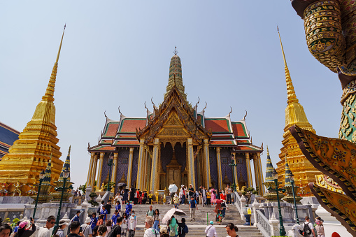 Many foreign tourists were walking towards the entrance of Wat Phra Kaew. Here are the main tourist attractions in Bangkok, Thailand.