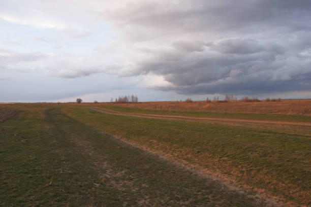 Dramatic pre-storm sky over the field. Spring landscape.