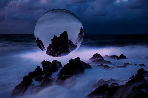 Stormy sea at night with futuristic sphere