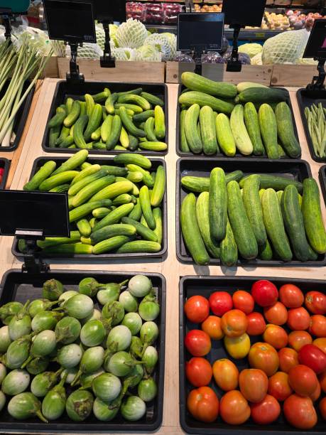 istock Supermarket shopboard with lug boxes with tomatoes, cucumbers and eggplant. Fresh vegetables for cooking at supermarket in Thailand. 2019803943