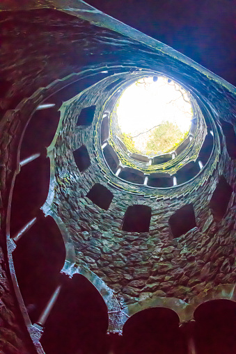 Sintra, Portugal - January 27, 2023: Initiation Well (Inverted tower) at park of Quinta da Regaleira palace in Sintra, Portugal