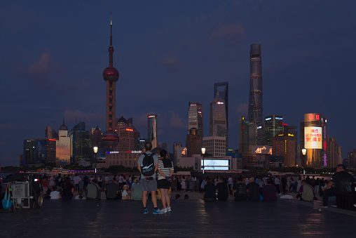Shanghai, China - September 01, 2023: People watching the Lujiazui city skyline of Pudong New Area at the viewing area along the Huangpu River