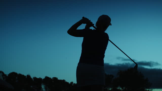 Silhouette of a Golf Player hitting the Golf Ball