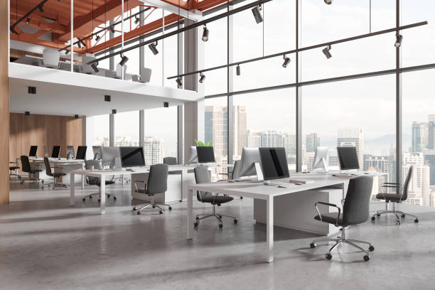 istock Modern coworking interior with desk and pc monitors in row, panoramic window 2019867342