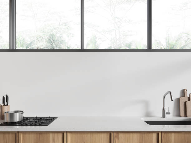 istock White hotel kitchen interior with cabinet, sink and kitchenware with window 2019869744
