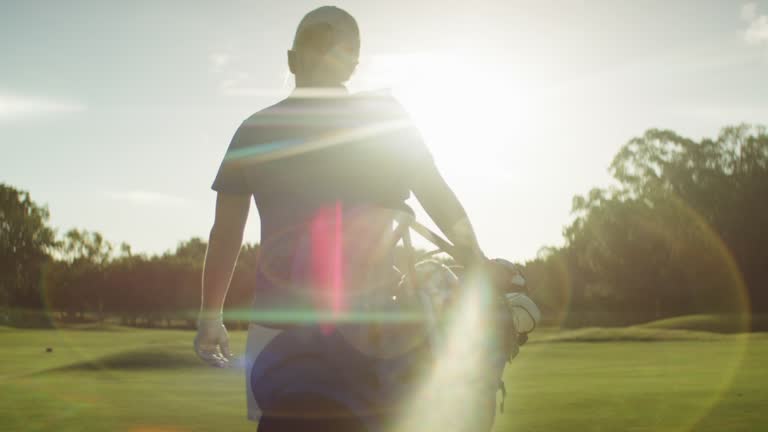 Golf Player Walking and carrying a heavy bag