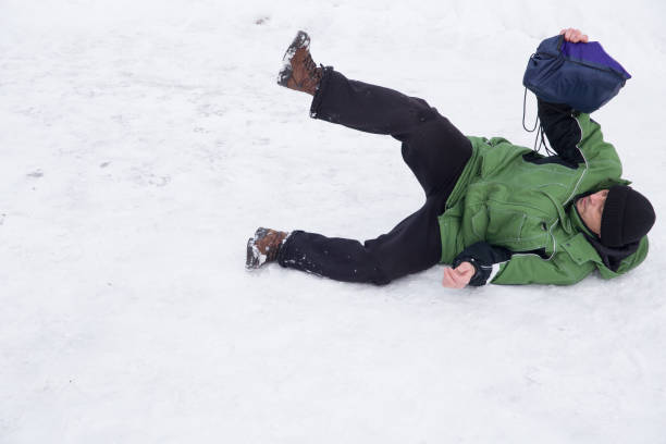 A man fell on a slippery winter road.