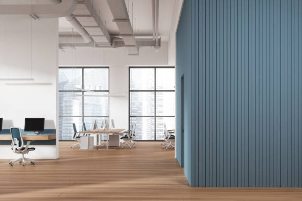 istock Business coworking interior with pc computers and armchairs, window. Empty wall 2019901898