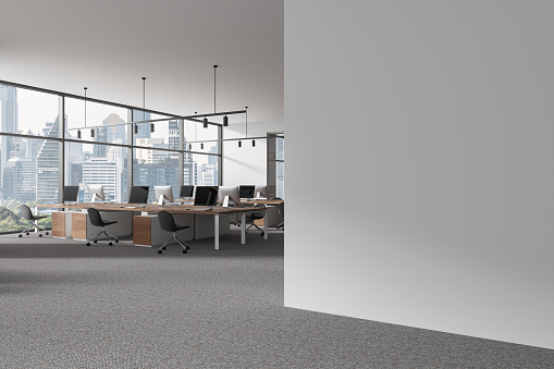 White office interior with armchairs and pc computers on desk, side view panoramic window on Bangkok skyscrapers. Modern coworking corner and mock up empty wall partition. 3D rendering